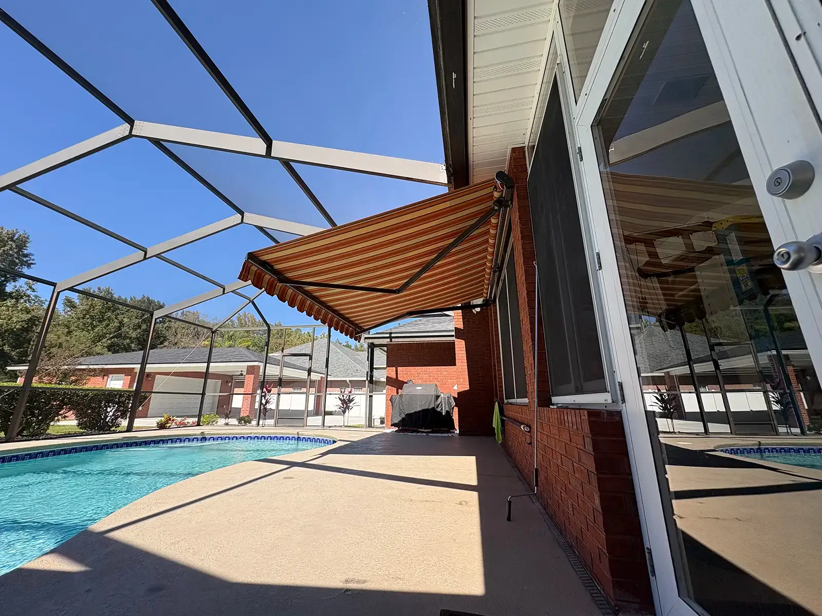 Motorized awning by pool - Palm Coast